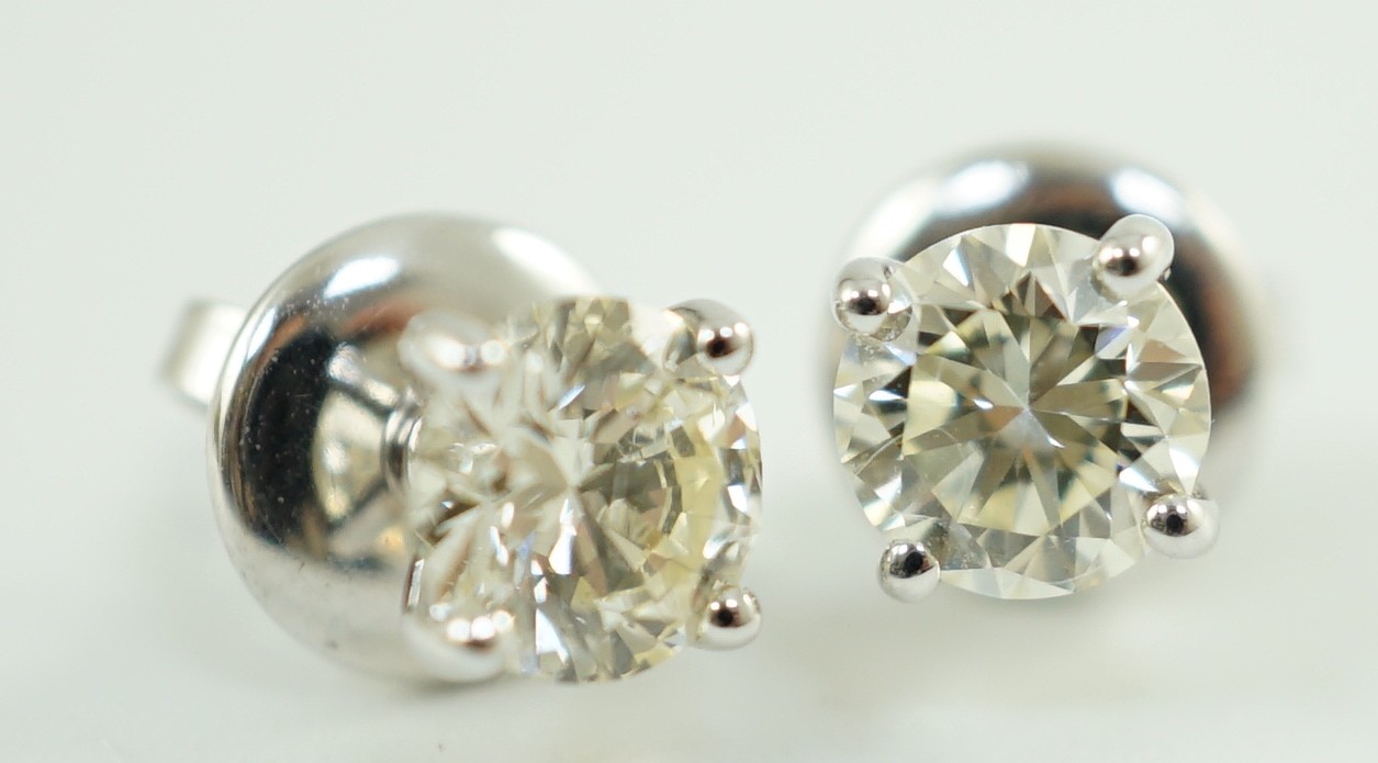 A pair of 18ct white gold and solitaire diamond set ear studs